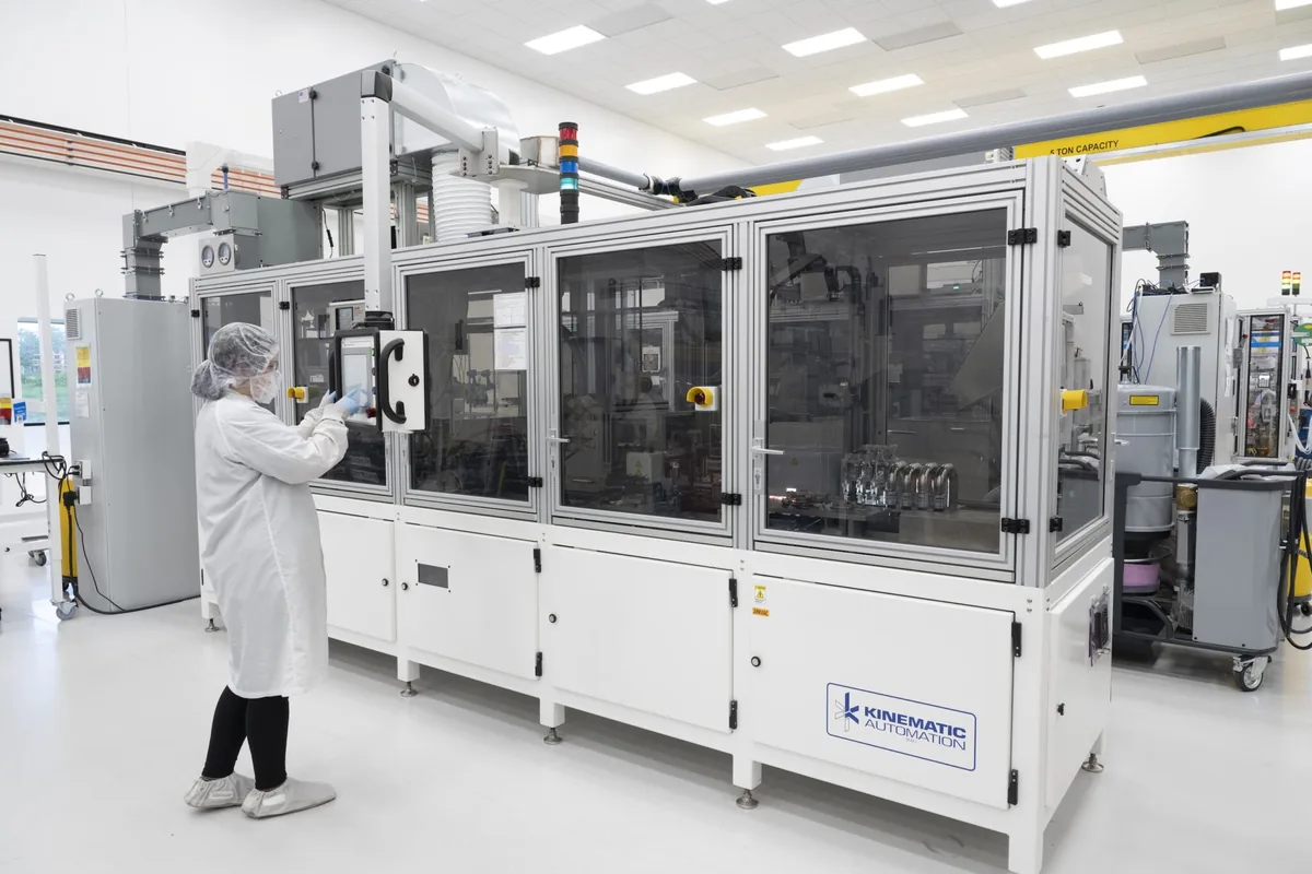 Gowned operator at an automated production cell in the IRP Medical ISO Class 8 cleanroom environment